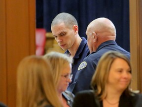 In this Thursday, Jan. 14, 2016, photo, Arron Lewis, top left, stands to be escorted from the courtroom during a lunch break in his  capital murder and kidnapping trial at the Pulaski County Courthouse in Little Rock, Ark. (Stephen B. Thornton/The Arkansas Democrat-Gazette via AP)