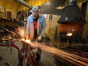 Blacksmith Scott McKay hammers a hot piece of steel in his workshop at Strong Arm Forge near Shedden in Elgin County. Like much of the larger business landscape, he is fuelled by creativity. For more on how McKay uses his old-fashioned forge to create unusual works of art, see the cover story in our Home section. (CRAIG GLOVER, The London Free Press)