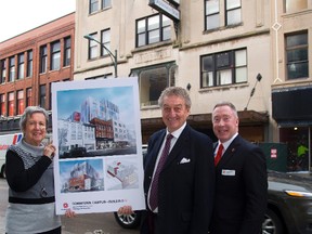 Helen and Andy Spriet and Fanshawe College president Peter Devlin show off the conceptual drawings of the Kingsmill building on Dundas Street in London. The facade will remain, with a restaurant on the main floor. (MIKE HENSEN, The London Free Press)