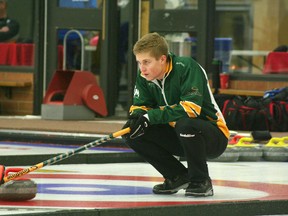 Thomas Scoffing puts down a brush at the Men’s Northern Alberta playdowns at  the Leduc Curling Club on Friday. MARK WIERZBICKI/LEDUC REP/POSTMEDIA