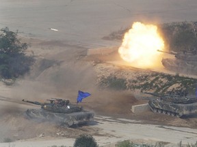South Korean army's K1A1 battle tank fires during the South Korea-U.S. joint military live-fire drills at Seungjin Fire Training Field in Pocheon, South Korea, near the border with North Korea, Friday, Aug. 28, 2015. The South Korean and U.S. soldiers held the combined live fire drill on Friday to display combined firing capabilities between South Korea and the U.S. militaries, showing that they are prepared to defend South Korea against North Korea's possible attack or provocations. (AP Photo/Ahn Young-joon)