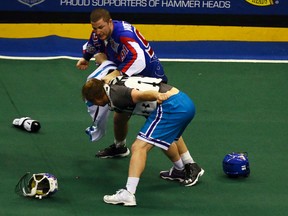 Billy Hostrawser of the Toronto Rock punches out Dylan Evans of the Rochester Knighthawks during NLL action on Jan. 14. (Dave Abel/Toronto Sun/Postmedia Network)