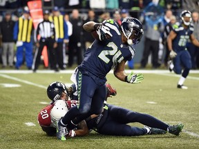 Marshawn Lynch of the Seattle Seahawks is tackled by Deone Bucannon of the Arizona Cardinals as he carries the ball during the first half at CenturyLink Field in Seattle on Nov. 15, 2015. (Steve Dykes/Getty Images/AFP)