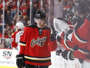 Sam Bennett looks little sheepish as he slaps gloves with his teammates during his four-goal effort against the Panthers. (Getty Images)