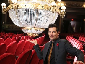Actor Chris Mann, who plays the phantom in The Phantom of the Opera, poses in front of the famous chandelier during a backstage tour. (Veronica Henri/Toronto Sun/Postmedia Network)