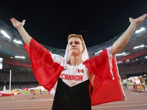 Canada’s Shawn Barber is shown celebrating after winning the gold medal in the men’s pole vault final at the World Athletics Championships at the Bird’s Nest stadium in Beijing, Monday, Aug. 24, 2015. (THE CANADIAN PRESS/Christian Charisius/dpa via AP)