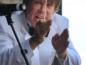 Conductor Alexander Mickelthwate exhorts a participant from the audience during a performance of Verdi's Anvil Chorus as part of Symphony in the Park, a free show from the Winnipeg Symphony Orchestra at the Lyric Theatre in Assiniboine Park on Sun., June 28, 2015. Two members of the audience banged on anvils. (Kevin King/Winnipeg Sun/Postmedia Network file)