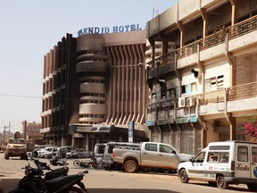 The Splendid Hotel, rear, which suspected militants attacked in Ouagadougou, Burkina Faso, Saturday, Jan. 16, 2016. The overnight seizure of a luxury hotel in Burkina Faso's capital by al-Qaida-linked extremists ended Saturday when Burkina Faso and French security forces killed four jihadist attackers and freed more than 126 people, the West African nation's president said. (AP Photo/Baba Ahmed)