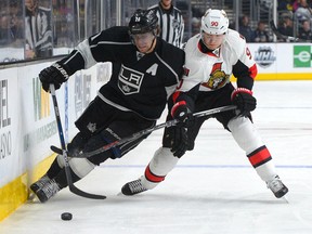 Jan 16, 2016; Los Angeles, CA, USA; Los Angeles Kings center Anze Kopitar (11) and Ottawa Senators right wing Alex Chiasson (90) battle on the boards in the second period of the game at Staples Center. Mandatory Credit: Jayne Kamin-Oncea-USA TODAY Sports