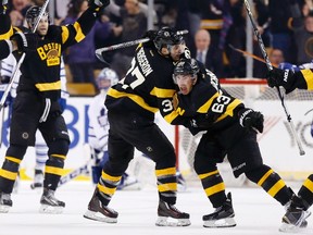 Boston Bruins' Brad Marchand (63) celebrates his goal with teammate Patrice Bergeron (37) during the third period of an NHL hockey game against the Toronto Maple Leafs in Boston, Saturday, Jan. 16, 2016. The Bruins won 3-2. (AP Photo/Michael Dwyer)