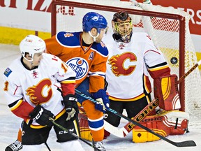 Edmonton's Taylor Hall (4) can't tip a shot past Calgary's goalie Jonas Hiller (1) during the second period of the Edmonton Oilers' NHL hockey game against the Calgary Flames at Rexall Place in Edmonton, Alta., on Saturday, Jan. 16, 2016. Codie McLachlan/Edmonton Sun/Postmedia Network
