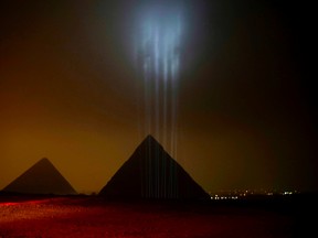 The Giza Pyramids are backlit ahead of a New Year's Eve fireworks display near Cairo, Egypt on Thursday, Dec. 31, 2015. (AP Photo/Maya Alleruzzo)