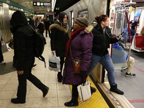 Riders board the subway at Yonge and Bloor during the TTC's second week of 8 a.m. Sunday subway start time Jan. 17, 2016. (Craig Robertson/Toronto Sun)