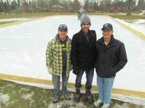 Bright's Grove Optimist Club members, from left, Ben Turner, Aaron Robb and Larry McLaren stand on Saturday January 16, 2016 in Sarnia, Ont.,  next to an outdoor skating rink the service club created at Lakeshore Community Church on Old Lakeshore Road. (Paul Morden, Sarnia Observer)