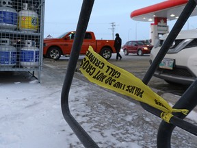 The tied end of police tape remains on a bicycle rack at the Petro-Canada station on Kenaston Boulevard on Jan. 16, 2016. A firearm was discharged during a robbery at the location in the early morning hours of Jan. 16. (Kevin King/Winnipeg Sun/Postmedia Network)