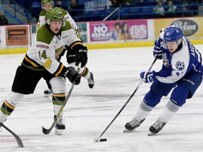 Zach Poirier, left, of the North Bay Battalion, and Mikkel Aagaard, of the Sudbury Wolves, battle for possession of the puck during OHL action at the Sudbury Community Arena in Sudbury, Ont. on Friday January 8, 2016. John Lappa/Sudbury Star/Postmedia Network