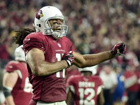 Arizona Cardinals wide receiver Larry Fitzgerald celebrates after a first down catch in overtime against the Green Bay Packers in a NFC Divisional round playoff game at University of Phoenix Stadium in Glendale on Jan. 16, 2016. (Matt Kartozian/USA TODAY Sports)