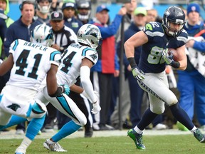 Seattle Seahawks tight end Luke Willson runs the ball as Carolina Panthers cornerback Josh Norman defends during the first quarter in a NFC Divisional round playoff game at Bank of America Stadium in Charlotte on Jan. 17, 2016. (John David Mercer/USA TODAY Sports)