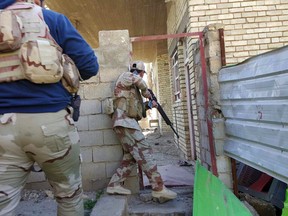 Iraqi security forces clear houses of Islamic State fighters in Ramadi, 70 miles (115 kilometers) west of Baghdad, Iraq, Sunday, Jan. 17, 2016. Ramadi, once home to 500,000 people, lies largely in ruins after months of air bombardment and the scorched-earth practices of IS fighters in retreat. The U.S-led coalition acknowledges the importance of rebuilding, but actual money for the effort falls far short. (AP Photo)
