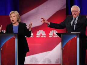 Democratic U.S. presidential candidate and former Secretary of State Hillary Clinton and rival candidate U.S. Senator Bernie Sanders speak simultaneously at the NBC News - YouTube Democratic presidential candidates debate in Charleston, South Carolina January 17, 2016. REUTERS/Randall Hill