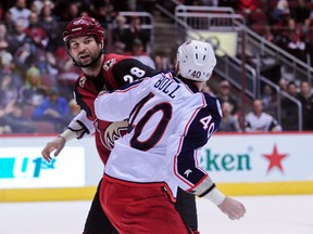 Arizona Coyotes left wing John Scott (28) and Columbus Blue Jackets right wing Jared Boll (40) fight during the second period at Gila River Arena on Dec. 17, 2015. (Matt Kartozian/USA TODAY)