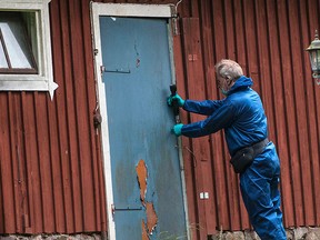 A police forensic officer works at a property outside Knislinge in southern Sweden, Tuesday, Sept. 22, 2015. (Johan Nilsson/TT via AP)