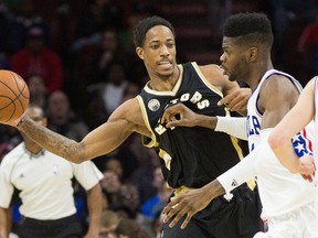 Toronto Raptors guard DeMar DeRozan passes the ball around Philadelphia 76ers forward Nerlens Noel during the first half at Wells Fargo Center. (Bill Streicher/USA TODAY Sports)