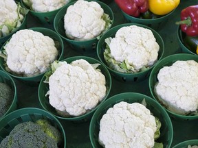 Cauliflowers, surrounded by broccoli and peppers, are seen at the Jean Talon Market, Monday, January 11, 2016 in Montreal. The soaring price of cauliflower is forcing restaurants offering signature dishes featuring the trendy vegetable to rethink menus and raise prices. (THE CANADIAN PRESS/Paul Chiasson)