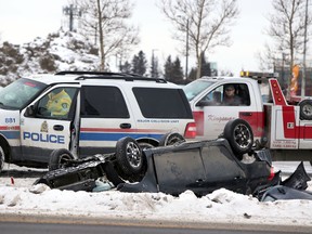 Police officers investigate a single vehicle rollover on Calgary Trail and Ellerslie Road in Edmonton, Alberta on January 18. 2016. Perry Mah/Edmonton Sun/Postmedia Network