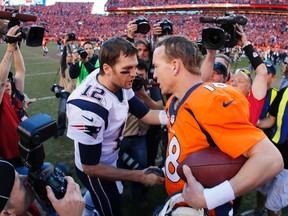 Tom Brady of the New England Patriots congratulates Peyton Manning of the Denver Broncos after the Broncos defeated the Patriots 26 to 16 during the AFC Championship game at Sports Authority Field at Mile High on January 19, 2014 in Denver, Colorado. (Kevin C. Cox/Getty Images/AFP)