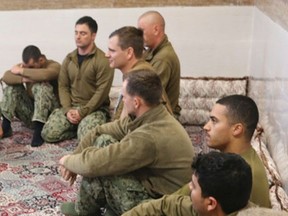 This picture released by the Iranian Revolutionary Guards on Wednesday, Jan. 13, 2016, shows detained American Navy sailors in an undisclosed location in Iran. The U.S. military released its first official account of Iran's seizure and subsequent release of 10 U.S. sailors. (Sepahnews via AP)