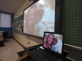A slideshow is projected in the classroom where victim Maude Carrier taught in Quebec City, Monday, Jan.18, 2016. The room was transformed by students and colleagues into a memorial after she died in a terrorist attack in Burkina Faso last week. Her mother Camille Carrier has called on Justin Trudeau to step up Canada's fight against terrorism. THE CANADIAN PRESS/Jacques Boissinot