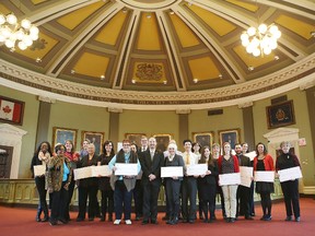 Kingston Mayor Bryan Paterson stands with the recipients of Heritage Fund grants on Monday at City Hall. (Elliot Ferguson/The Whig-Standard)