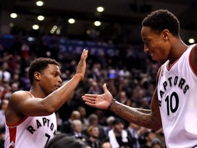 Toronto Raptors' DeMar DeRozan and Kyle Lowry celebrate the dying seconds of a win over the Brooklyn Nets at the Air Canada Centre in Toronto\ on Jan. 18, 2016. (THE CANADIAN PRESS/Frank Gunn)
