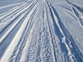 Snowmobile tracks are pictured in the snow in this file photo. (Fotolia)