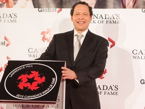 Lawrence Hill poses for photographs with his plaque as he in inducted into Canada's Walk of Fame during an event in Toronto on Saturday, November 7, 2015. THE CANADIAN PRESS/Chris Young