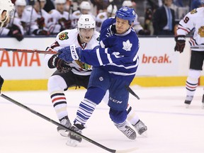 Toronto Maple Leafs right wing Michael Grabner (40) shoots as Chicago Blackhawks defenceman Trevor van Riemsdyk (57) defends at Air Canada Centre. (Tom Szczerbowski-USA TODAY Sports)