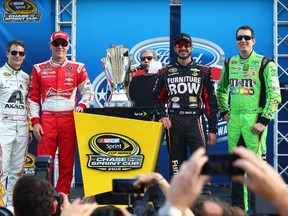 Chase finalists and NASCAR Sprint Cup Series drivers (from left) Jeff Gordon, Kevin Harvick, Martin Truex Jr. and Kyle Busch stand next to the championship trophy before the Ford EcoBoost 400 at Homestead-Miami Speedway. (Mark J. Rebilas/USA TODAY Sports)