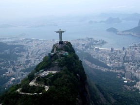 In this Oct. 9, 2015, file photo, the Christ the Redeemer statue is shown in this aerial view of Rio de Janeiro,Braizl. (AP Photo/David J. Phillip, File)