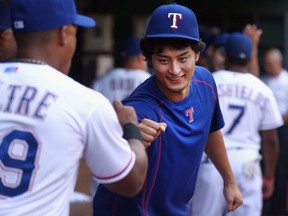 Yu Darvish #11 of the Texas Rangers fist bumps Adrian Beltre #29 of the Texas Rangers before the Rangers take on the Toronto Blue Jays at Globe Life Park in Arlington on August 26, 2015 in Arlington, Texas.   Tom Pennington/Getty Images/AFP