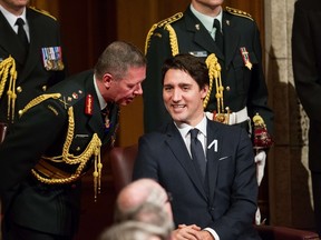 Prime Minister Justin Trudeau, right, speaks with Chief of the Defence Staff General Jonathan Vance as they await the Speech from the Throne in Ottawa on December 4, 2015. AFP PHOTO/GEOFF ROBINS