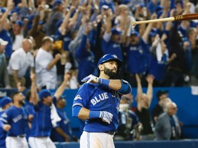 Jose Bautista of the Blue Jays hits a three-run homer in the seventh Inning against the Texas Rangers in Game 5 of an American League Division Series in Toronto on Oct. 14. (Stan Behal/Postmedia Network)