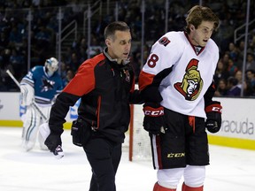 Ottawa Senators' Mike Hoffman is taken off the ice after a collision with San Jose Sharks goalie Alex Stalock on Jan. 18. (The Associated Press)