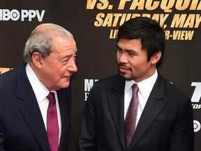 This file photo taken on March 11, 2015 shows boxer Manny Pacquiao listening to promoter Bob Arum on arrival in Los Angeles.  (AFP PHOTO/FILES/FREDERIC J. BROWN)