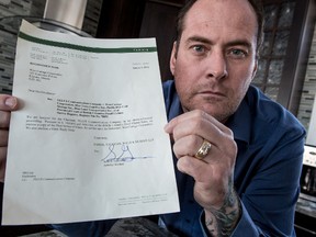 Kevin West holds the cover letter he received from a law firm naming him in a lawsuit in B.C. small claims court. IERROL MCGIHON, Ottawa Sun)