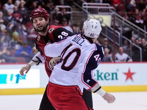 Arizona Coyotes left winger John Scott and Columbus Blue Jackets right winger Jared Boll fight during the second period at Gila River Arena in Glendale, Ariz., on Dec. 17, 2015. (Matt Kartozian/USA TODAY Sports)
