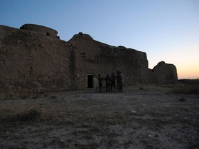 In this Aug. 21, 2009, photo released by the U.S. Army, visitors assigned to the Logistic Civil Augmentive Program from Forward Operating Base Speicher, near Tikrit, Iraq, stand at the entrance to the ruins of St. Elijah’s Monastery after completing a tour there, at Forward Operating Base Marez in Mosul, Iraq. The 1,400-year-old monastery has been reduced to a field of rubble, yet another victim of the Islamic State's relentless destruction. (MC1 (SCW) Carmichael Yepez/U.S. Army via AP)
