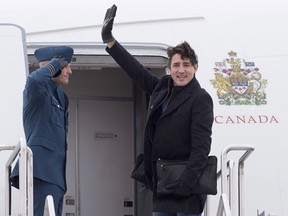 Prime Minister Justin Trudeau waves as he boards his aircraft in Fredericton, N.B., on Jan. 19, 2016, as he heads to Davos, Switzerland, for the World Economic Forum. (THE CANADIAN PRESS/Andrew Vaughan)