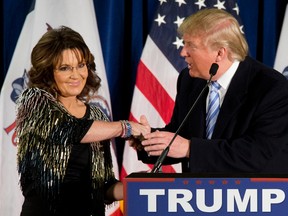 Former Alaska Gov. Sarah Palin, left, endorses Republican presidential candidate Donald Trump during a rally at the Iowa State University, in Ames, Iowa, on Jan. 19, 2016. (AP Photo/Mary Altaffer)