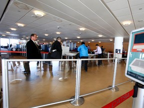 Passengers clear a Canadian Air Transport Security Authority (CATSA) security station at Richardson International Airport. (Tom Braid/Postmedia Network file photo)